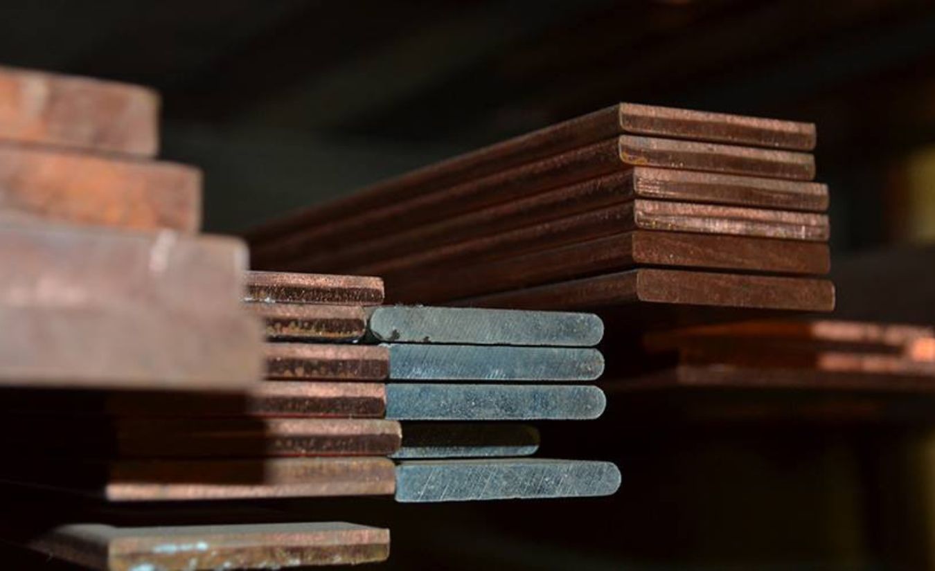 Stacked cut metal bars at Metals 'R' Us shop
